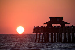 sunset at municipal pier of Naples, Florida, USA