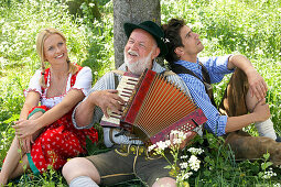 Couple listening to man playing melodeon