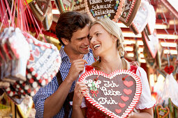 Man giving woman a chocolate heart