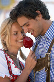 Couple eating candied apple