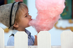 Boy (3-4 years) eating cotton candy