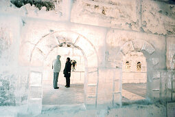 A couple in an ice castle at Lake Louise at night, Alberta, Canada