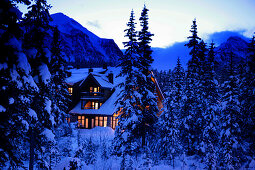 Snow covered log house, Post hotel, lake louise, Alberta, Canada