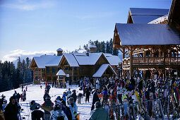 Skiers and snowboarders waiting at the base station at Lake Louise ski resort, Lake Louise, Alberta, Canada