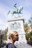 Young woman at Place Guilleaume, equestrian sculpture of William II in background, Luxembourg, Luxembourg