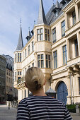 Young woman in front of Grand Ducal Palace, Luxembourg
