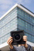 Young woman holding a large format camera in hands, Luxembourg