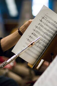 Transverse flute player with music sheet, Munich Symphonic Orchestra, Germany