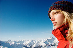 Reflective young woman looking at view, mount Rohnenspitze, Tannheim Valley, Tyrol, Austria