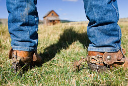 Cowboy boots and barn, wildwest, Oregon, USA