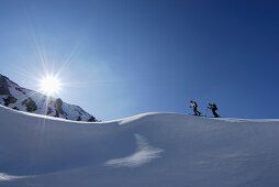 Two back-country skiiers on snow cornice, Tschachaun, Lechtal Alps , Vorarlberg, Austria