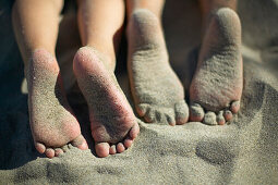 Girl's feet on sand, Spiekeroog island, East Frisian Island, Lower Saxony, Germany