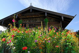 Flower garden in front of farmhouse, Petting, lake Waginger See, Chiemgau, Upper Bavaria, Bavaria, Germany