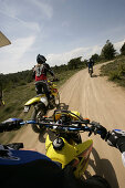 People driving offroad with motocross motorbikes, Suzuki Offroad Camp, Valencia, Spain