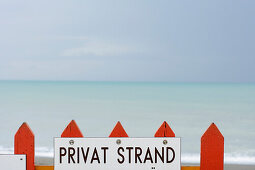 Sign on a fence of a private beach, North Sea, Germany