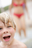 Wet boy (3-4 years) laughing at camera, Bavaria, Germany, MR