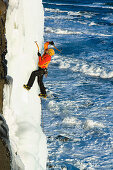 Ice climber at coast, Iceland
