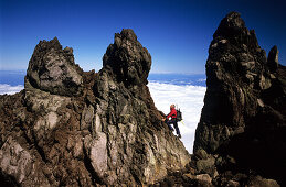 Man climbing on solidified lava spires, North Island, New Zealand
