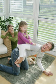 Family playing in living room, Munich, Germany