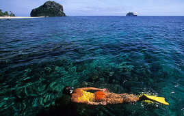 Woman snorkeling off Navadra Island, Mamanuca group, Fiji, South Sea