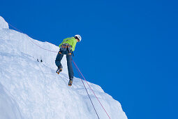 Teenager abseiling from Corn Diavolezza (man-made icefall), Pontresina, Upper Engadin, Grisons, Switzerland