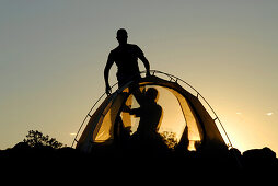 Two people putting up a tent, Camping, Sardegna, Sardinia, Italy, Europe, mr