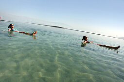 Women floating in the Dead Sea, Ein Bokek, Israel