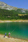 Fishermen at lake Lago Palü, Bernina range, Italy