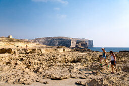 People walking over a cliff near Dwejra Point, Gozo, Malta, Europe