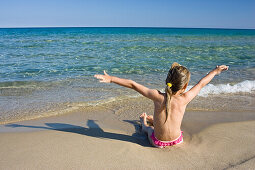 little girl playing at the beach, Sardinia, Italy