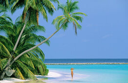 Woman on tropical beach. Maldives Islands