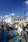 Waterworks between Alexander garden and Manege square with the Manege building in the back, Moscow, Russia