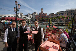 Waiters and people on the terrace of Cafe Saraceno near Rialto Bridge, Venice, Veneto, Italy