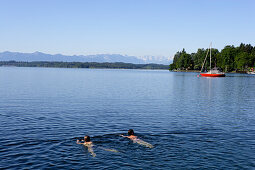 A couple swimming in lake Starnberg, Tutzing, Bavaria, Germany