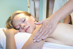 headshot of girl having a back massage in a salon