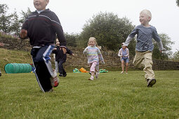 Group of pre school children doing a running race on sports day