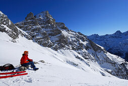 Young woman resting at mount Kreuzkopf, Allgaeu Alps, Tyrol, Austria