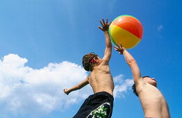 young boys playing with a beach ball