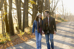 Couple walking on country road in autumn