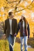 Couple walking on country road in the fall