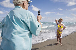 Taking picture of his wife in fun tee-shirt