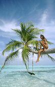 Girl in palm tree. Meerufenfushi Island. North Male Atoll .Maldives