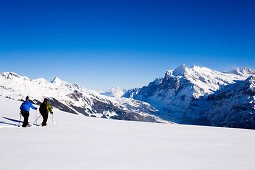Two persons snowshoeing, Maennlichen, Grindelwald, Bernese Oberland, Canton of Bern, Switzerland