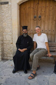 Father Neofytos, Orthodox priest, with photographer Juergen Richter in front of a monastery, Omodos, Troodos mountains, Cyprus