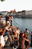 Young people on the river bank, Riviera Klein-Basel, Basel, Switzerland