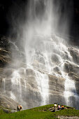 Couple watching Fallbach Waterfall, Malta Valley, Hohe Tauern National Park, Carinthia, Austria