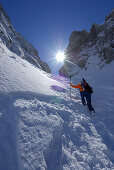 Female backcountry skier ascending, Griesner Kar, Wilder Kaiser, Kaiser range, Tyrol, Austria