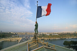 French tricolore, French flag being hoisted on the roof of the National Assembly, view across the Seine and Place de la Concorde, Paris, France