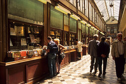 People in front of a second hand bookshop at Passage Jouffroy, 9. Arrondissement, Paris, France, Europe