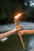 Hands holding torch